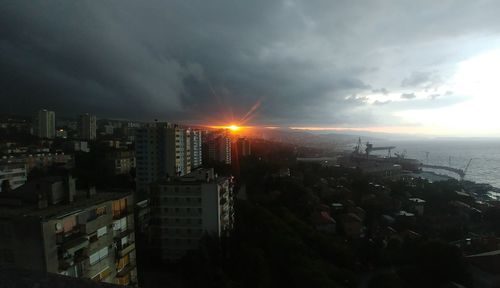 High angle view of buildings in city against sky during sunset