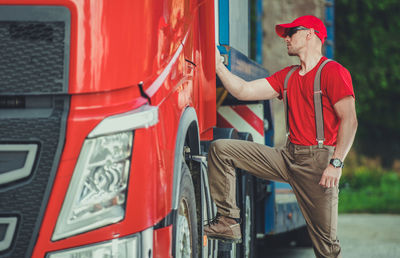 Mature man standing by truck