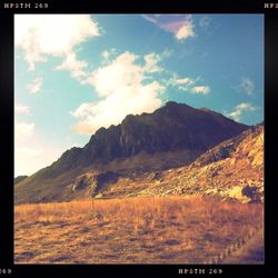 Scenic view of mountains against cloudy sky