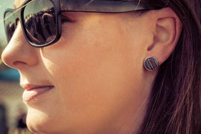 Close-up portrait of young woman wearing sunglasses