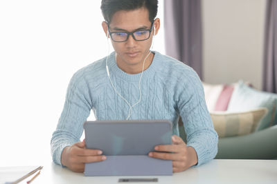 Midsection of man using mobile phone