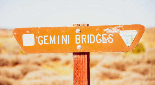 Close-up of road sign on field gemini bridges
