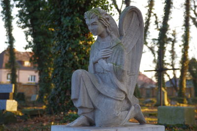 Statue against trees