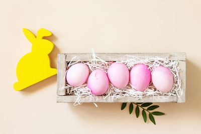 Directly above shot of christmas decorations on pink background