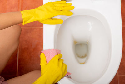 Midsection of woman washing hands in bathroom