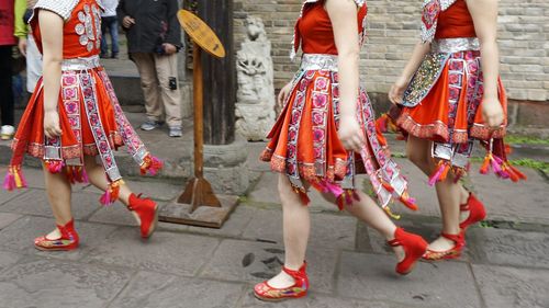 Low section of women walking on street