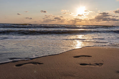 Scenic view of beach against sky during sunset