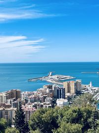 High angle view of cityscape by sea against sky