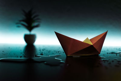 Paper boat on wet table