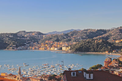 High angle view of townscape by sea against sky