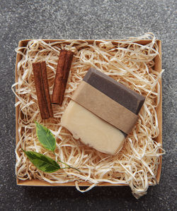 Natural handmade soap with cinnamon on straw background