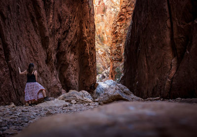 Rear view of man standing in cave