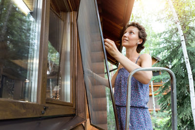 Low section of woman sitting on escalator