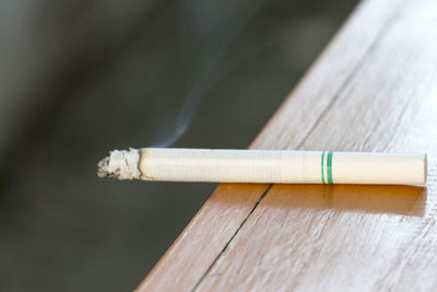 High angle view of burning cigarette on table
