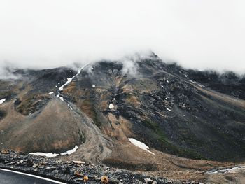 Road side view of mountains against clouds in high altitude area