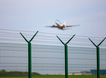 Full frame of fence at airport and airplane