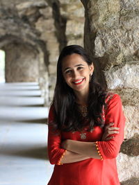 Portrait of a smiling young woman standing outdoors