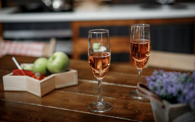 Close-up of wine glasses on table