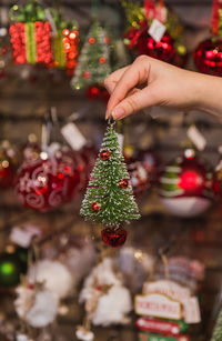 Midsection of woman decorating christmas tree