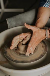 Midsection of person preparing food in kitchen