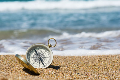 Close-up of clock on beach