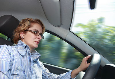 Mature woman driving car