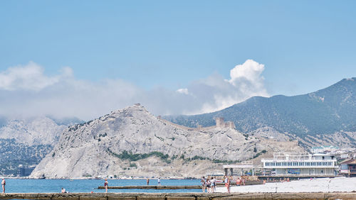 Scenic view of mountains and sea against sky