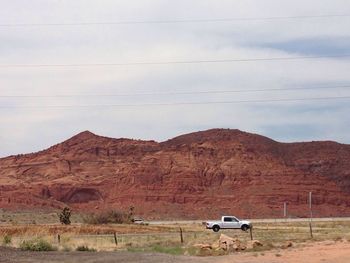 Car in front of red rocks