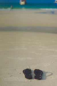 High angle view of shoes on sand at beach
