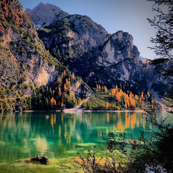 Scenic view of lake by mountain against sky