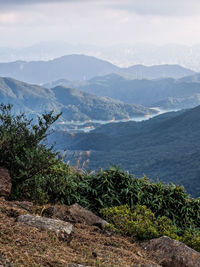 Scenic view of sea and mountains against sky