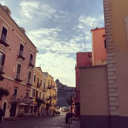 Street amidst buildings against sky in city