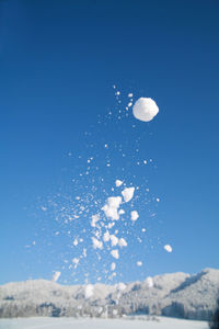 Low angle view of moon against clear blue sky