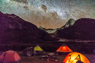 Scenic view of mountains against sky at night