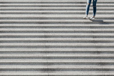 Low section of person walking on staircase