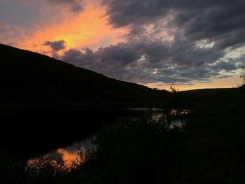 Scenic view of landscape against cloudy sky