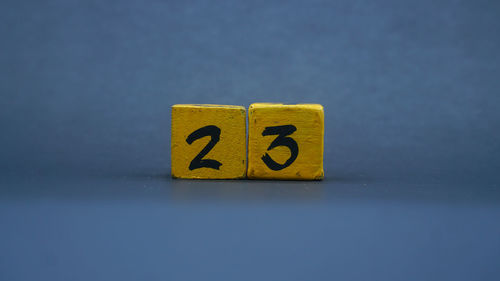 Close-up of toy blocks on yellow background