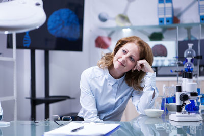 Portrait of female doctor examining patient in gym