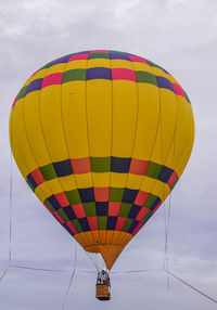 Low angle view of yellow hot air balloon against sky