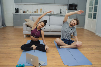Full length of woman exercising in gym