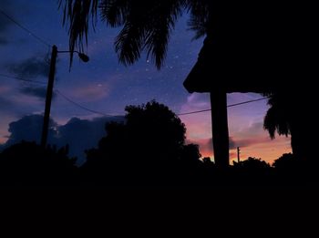 Low angle view of silhouette trees against sky at dusk