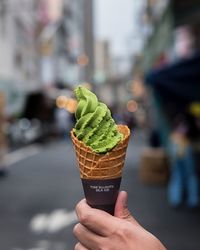 Midsection of woman holding ice cream