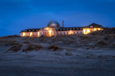 Illuminated building during winter at dusk