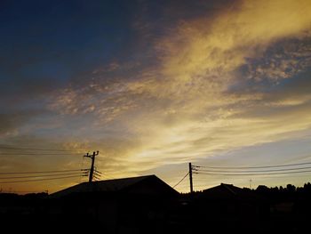 Silhouette buildings against sky during sunset