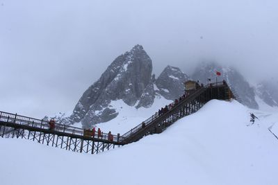 Scenic view of snow covered mountain against sky