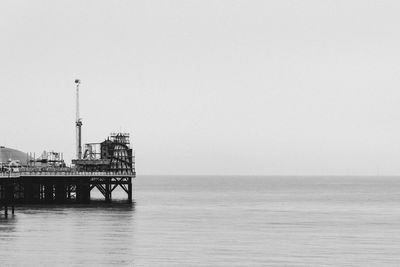 Pier park with sea against clear sky