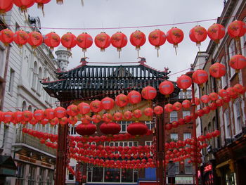 Low angle view of lanterns hanging against sky in city
