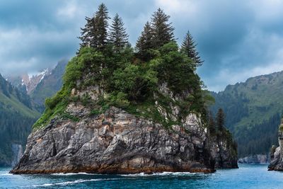Scenic view of sea and mountains against sky
