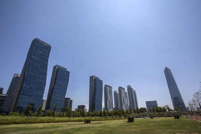 Low angle view of skyscrapers against clear sky seen from songdo central park