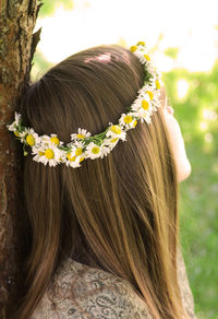 Close-up of woman with white flowers